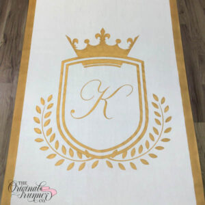 Make a regal statement with this simple royal shield frame, adorned with a thick gold crown positioned at the top. The large crown adds a touch of grandeur, while a simple wheat graphic curves along the bottom of the frame. This custom hand-painted design is perfect for a personalized wedding aisle runner. "K" wedding logo.