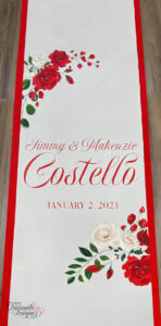 When your new last name takes center stage, celebrate it with a custom aisle runner featuring white and red roses for a striking design. Choose to include your first names or keep it sleek and focused on your cherished surname. Elevate your wedding decor with this personalized and meaningful touch.